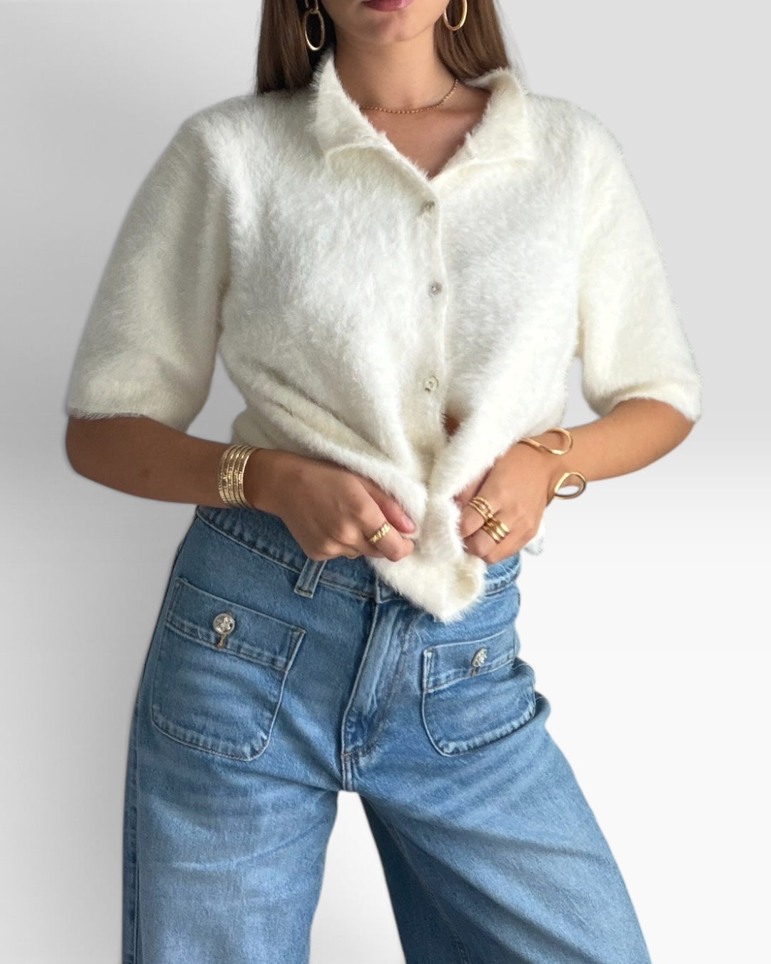 Gilet Nuage HELLES blanc en maille douce à manches courtes et fermeture boutonnée porté avec un jean bleu